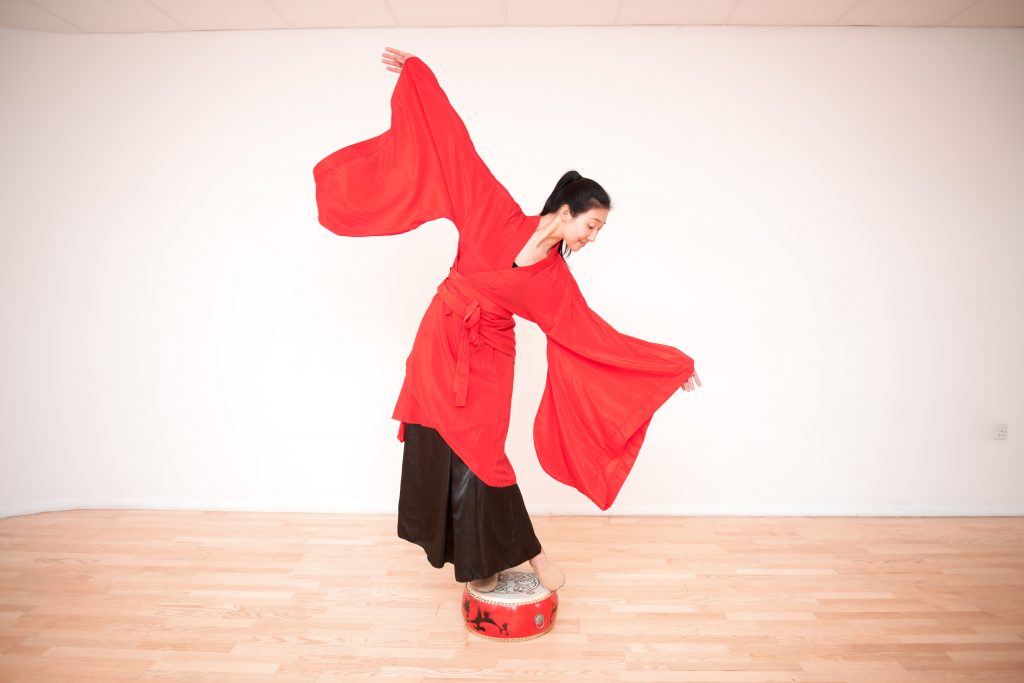 Teacher demonstrating Chinese Folk drum dance with short sleeves